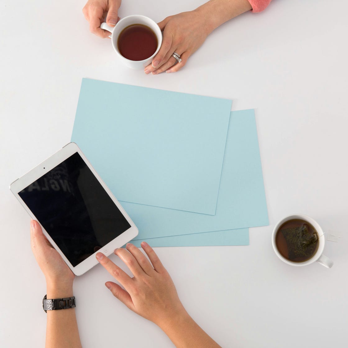 From above of dollar bills in opened black envelope placed on stack of United states cash money as concept of personal income